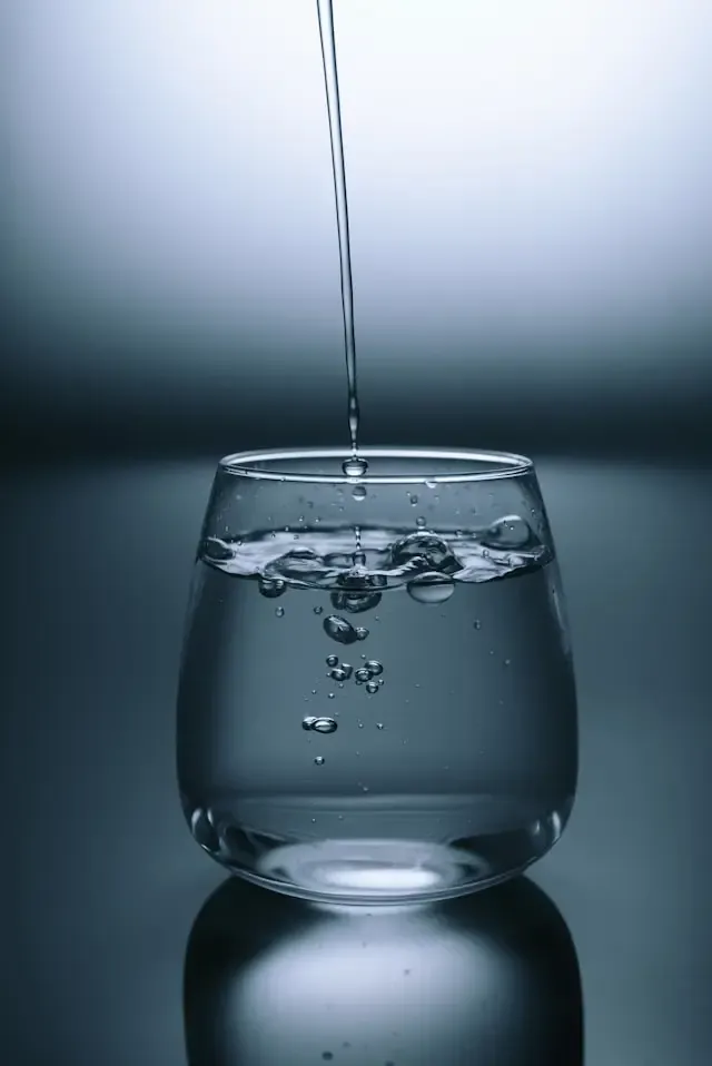 A clean glass of clear drinking water on a table