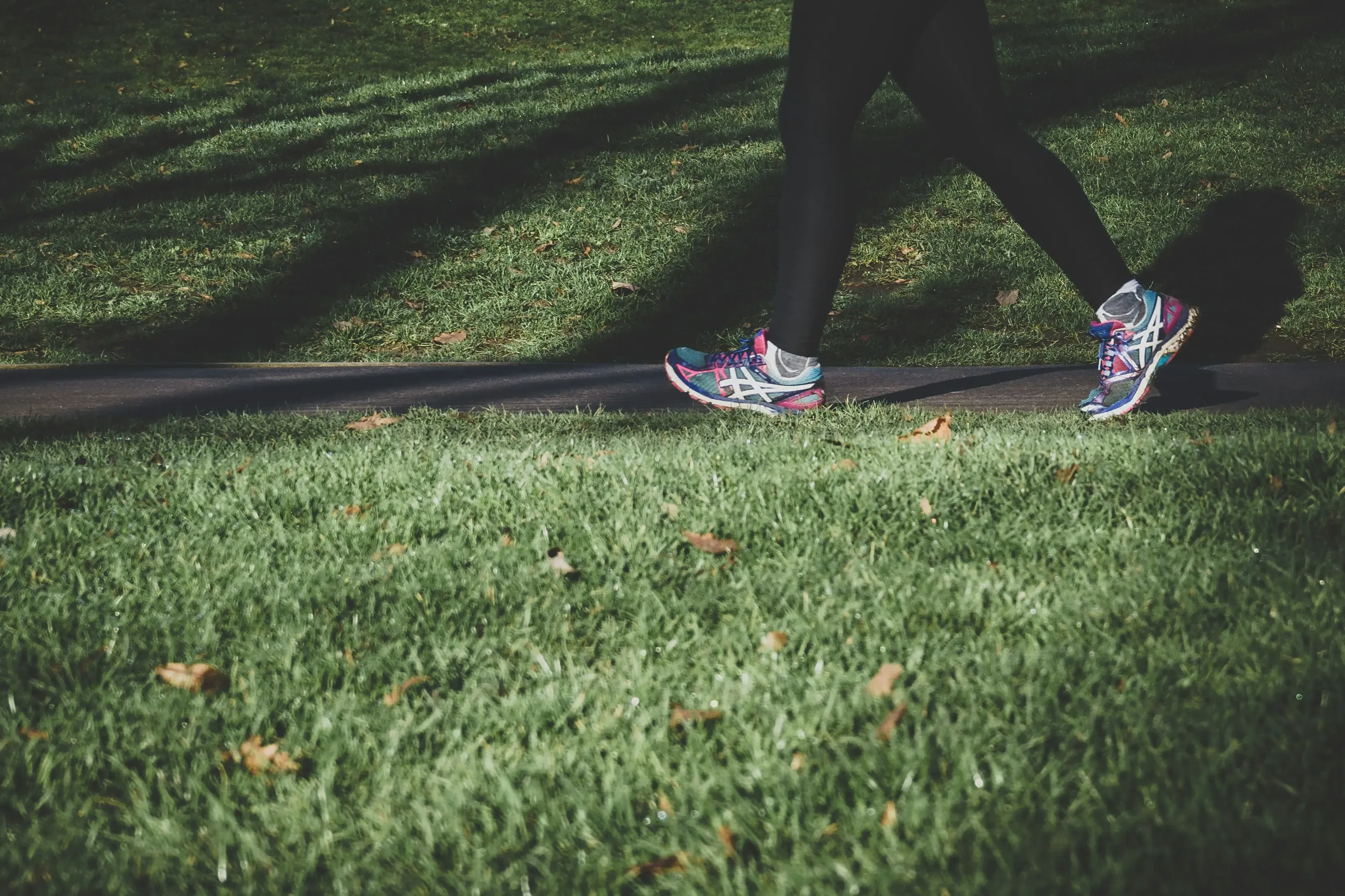 A person walking outdoors on a path during morning hours